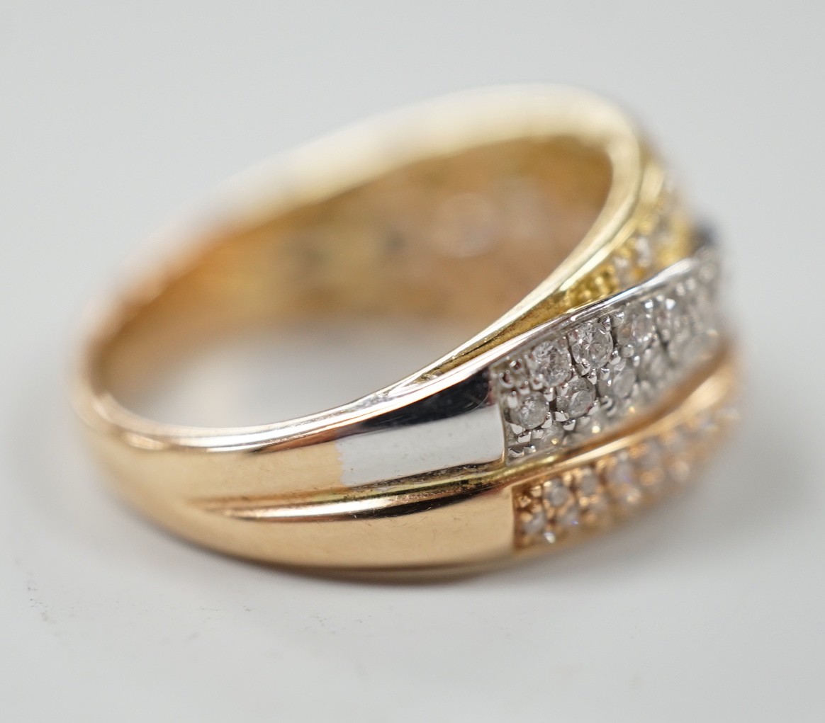 A modern three colour 18ct gold and diamond chip cluster set three row crossover ring, size O, gross weight 6.9 grams.